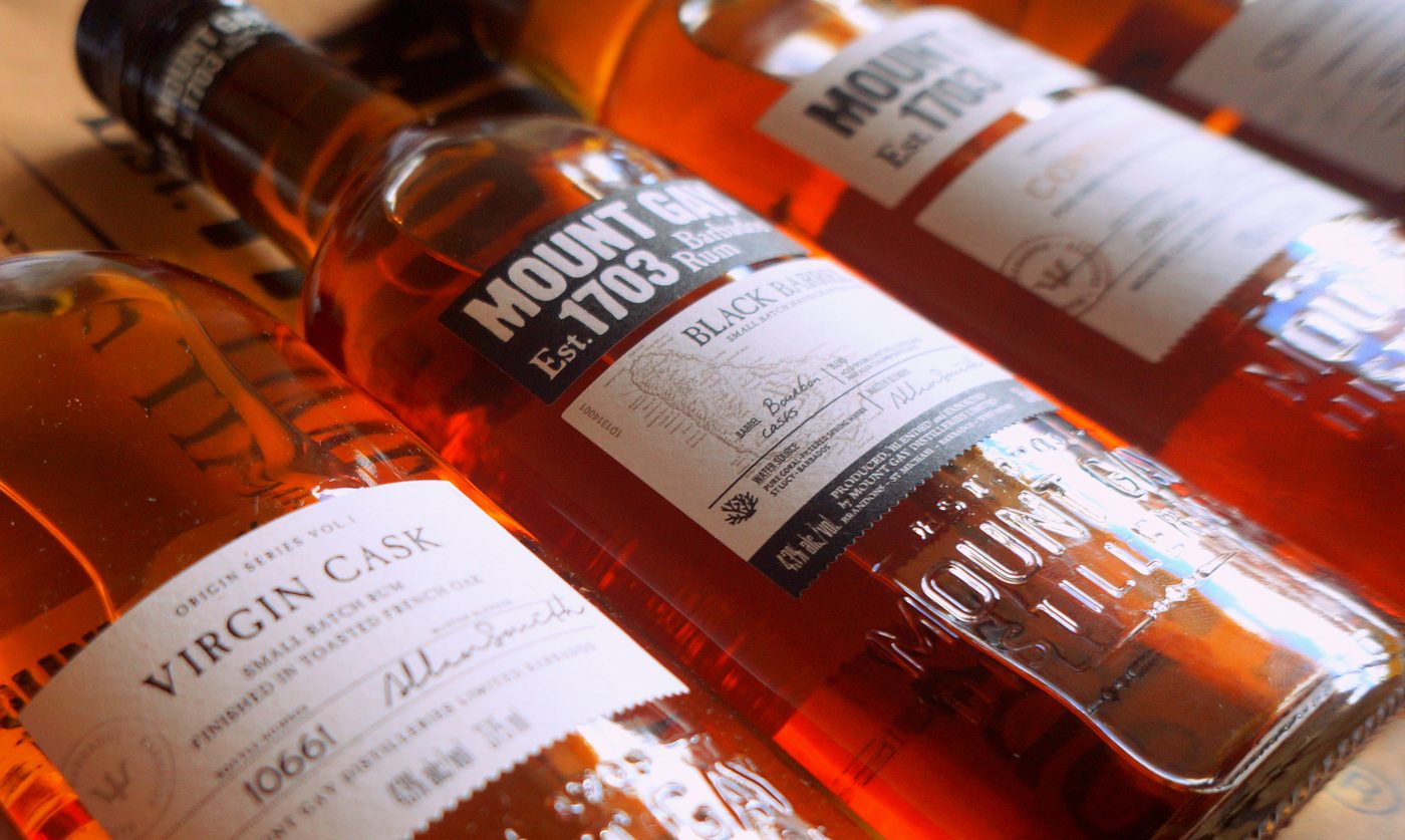 Mount Gay Black Barrel rum between two limited-edition Mount Gay bottles