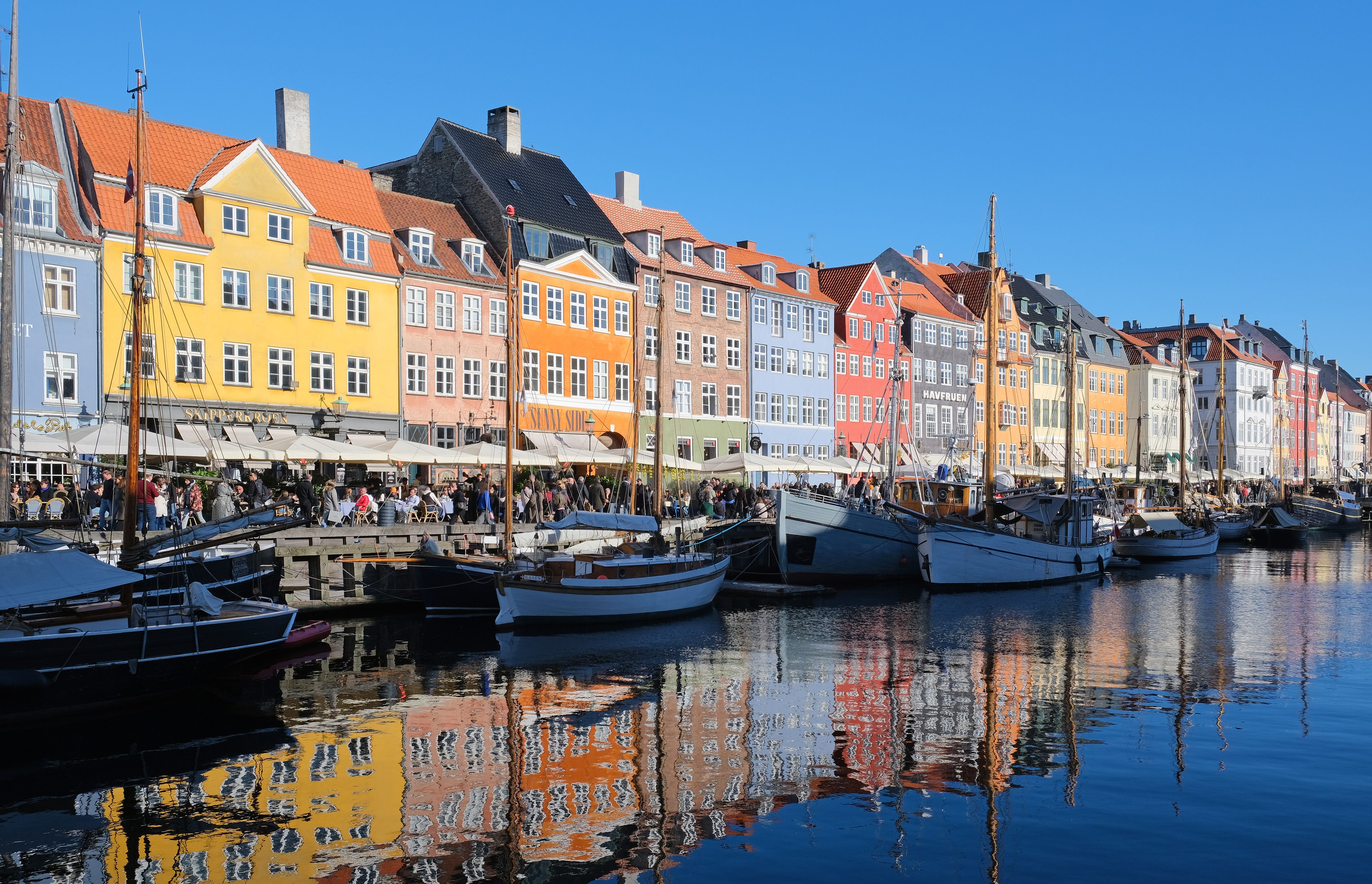 Colorful townhouses and moored boats along the Nyhavn canal in Copenhagen