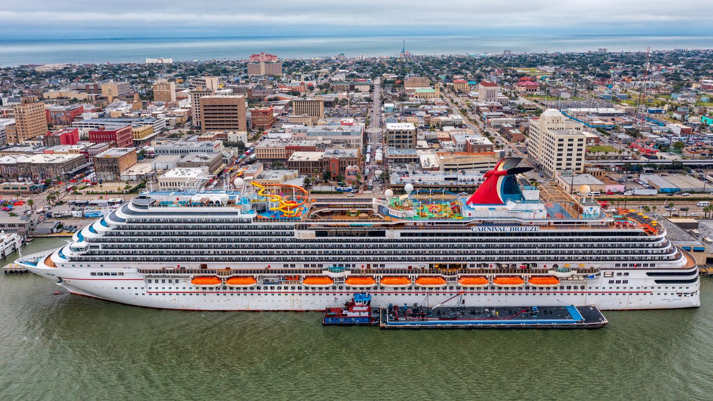 Carnival Breeze docked at Galveston with the island behind it