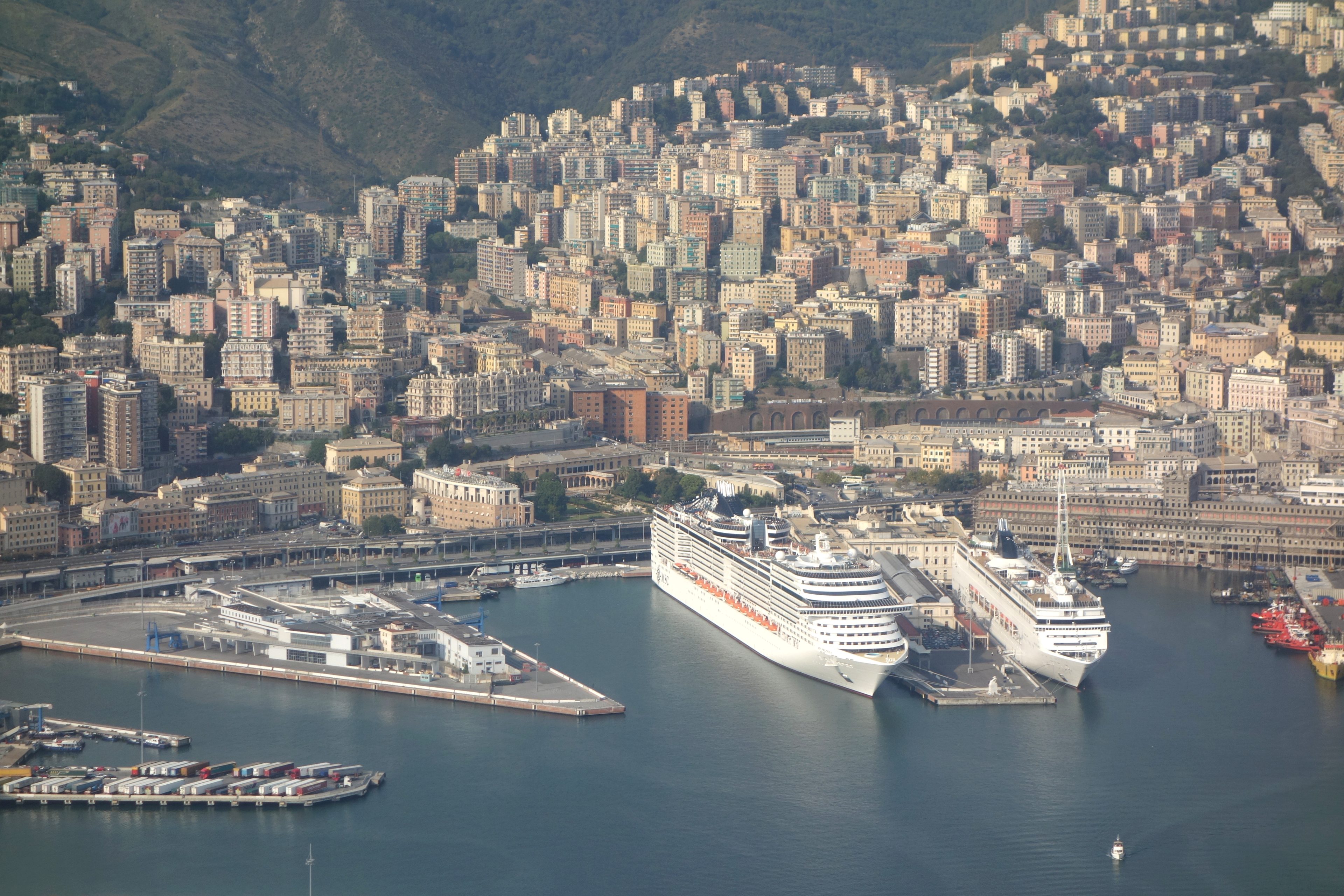 Aerial view of Genoa harbor with large ships at the quays
