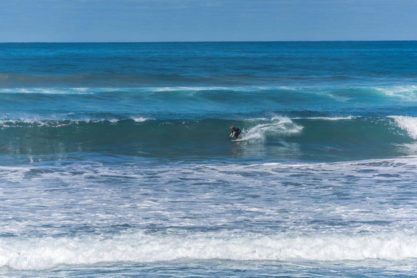 A bodyboarder riding a wave at Playa de las Canteras