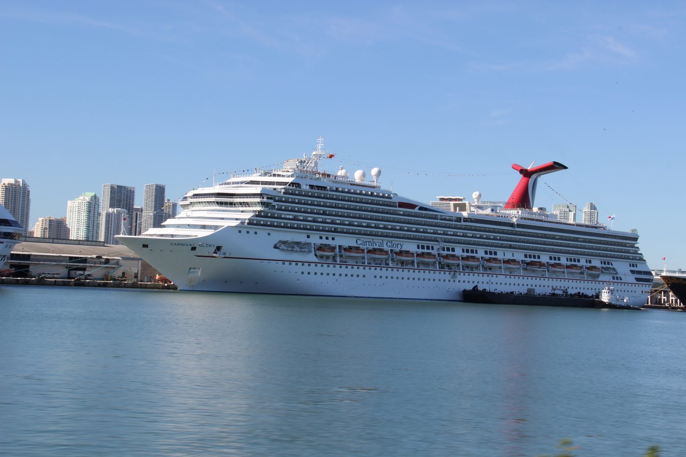 Carnival Glory docked at PortMiami with the Miami skyline behind it