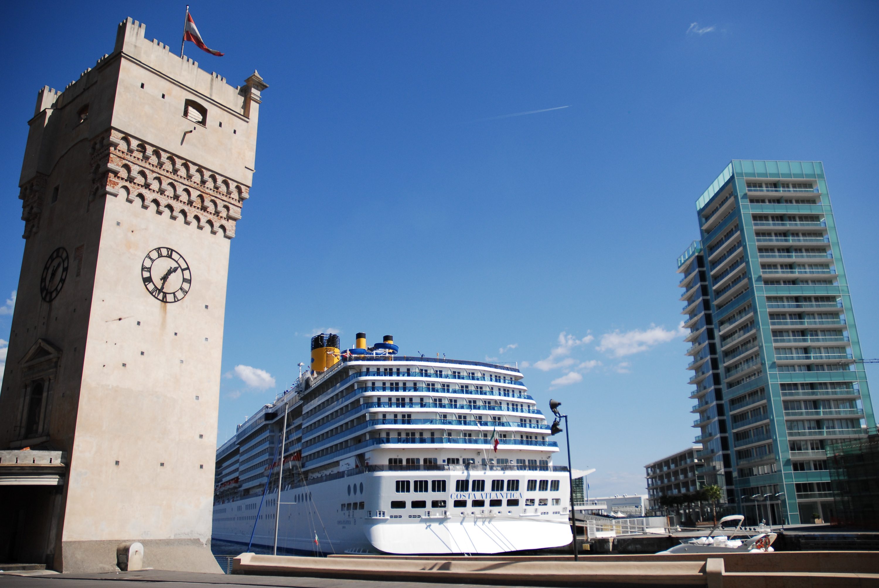 The Torretta clock tower in the port of Savona with a Costa ship behind it