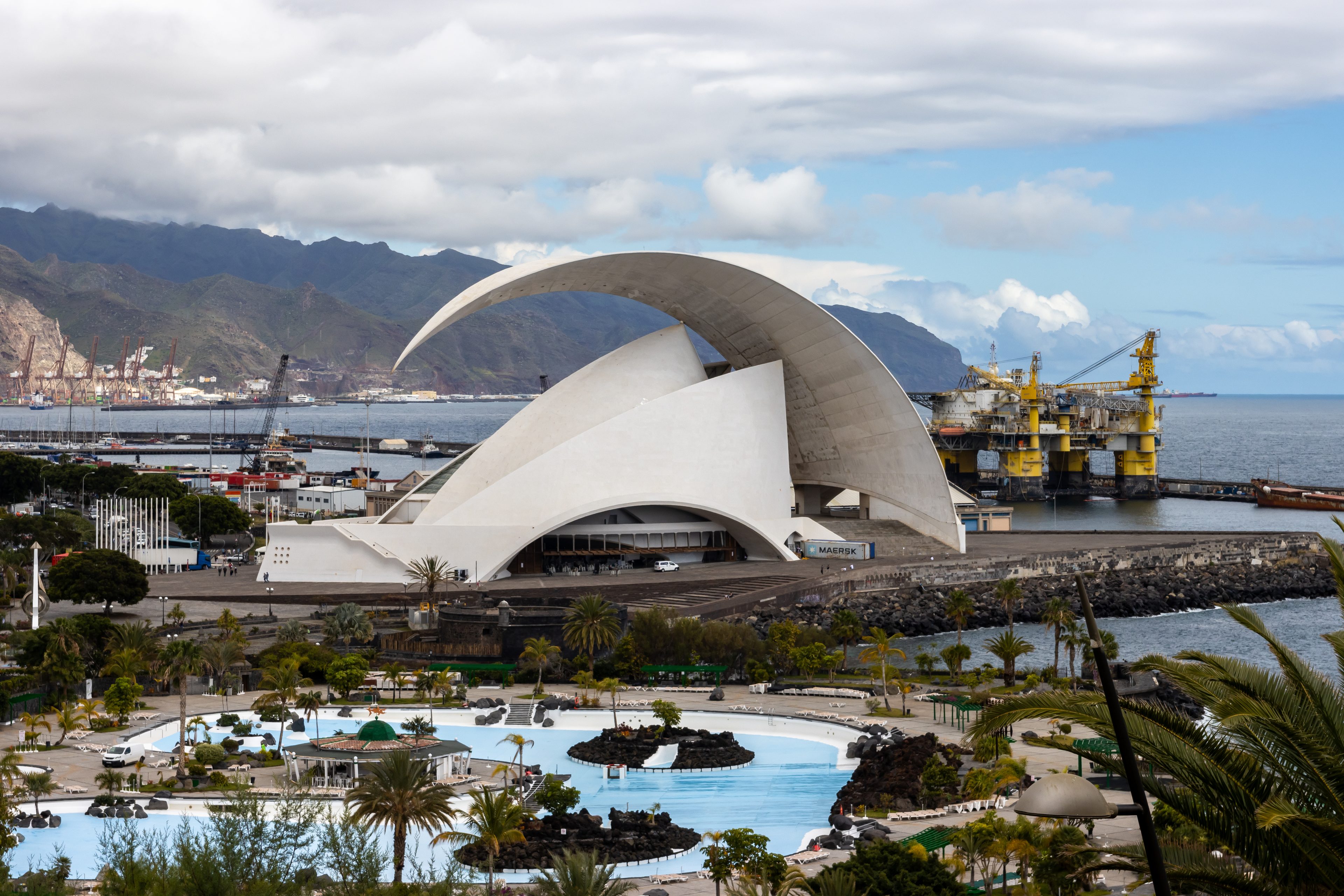 The Auditorio de Tenerife beside the Palmetum lagoons, with the port and the Anaga hills behind