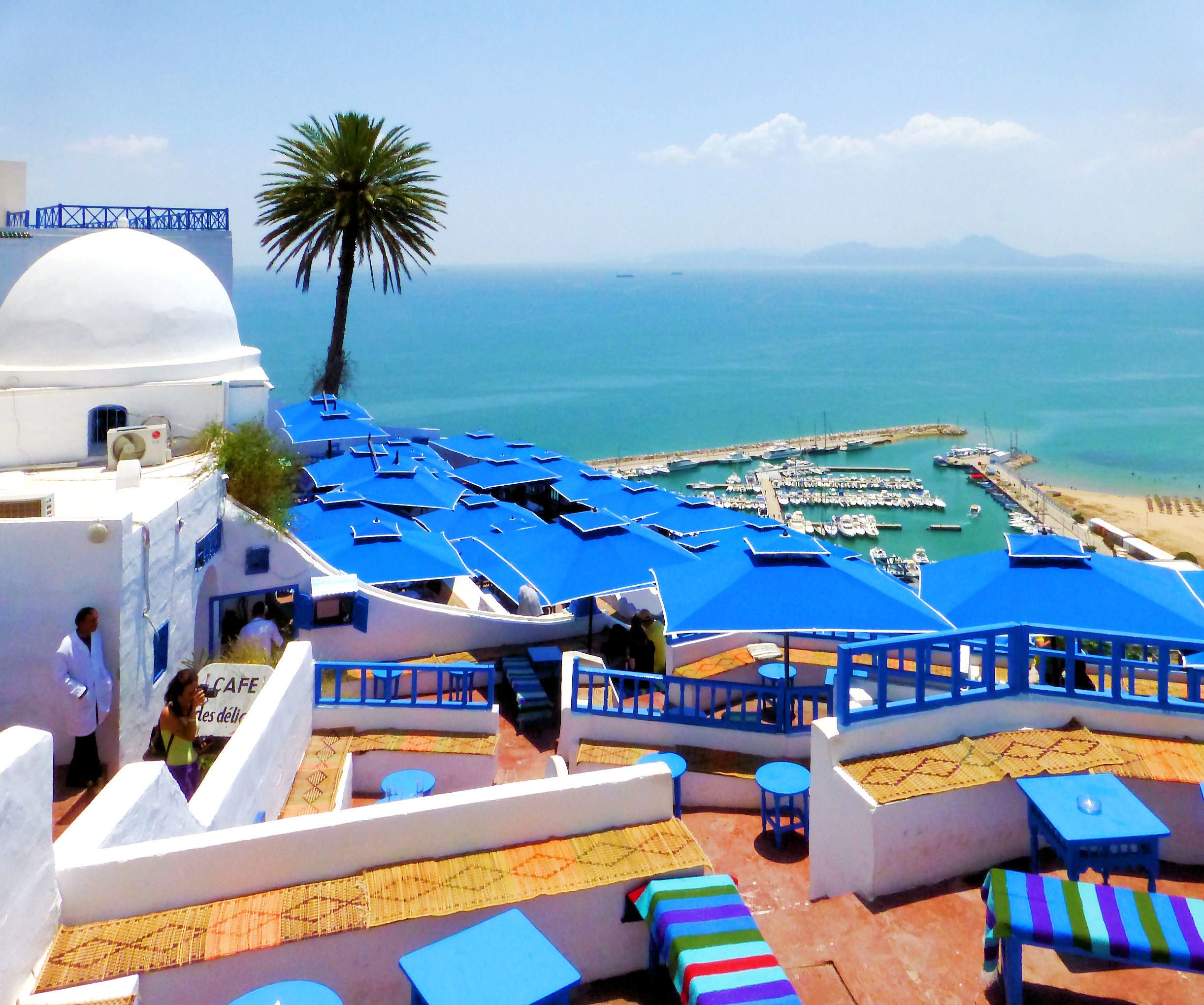 Blue umbrellas, white walls and the marina below Sidi Bou Said