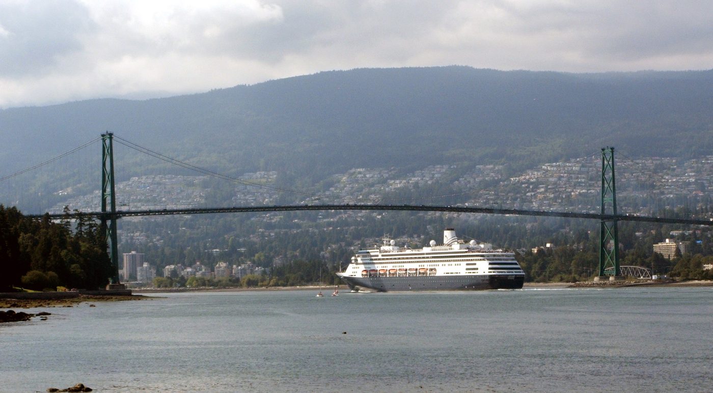 A cruise ship passing under Lions Gate Bridge in Vancouver